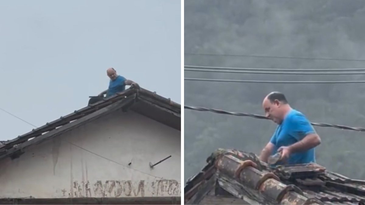 Homem sobe em telhado sem equipamentos de segurança para consertar estrutura em meio à chuva na Grande Florianópolis